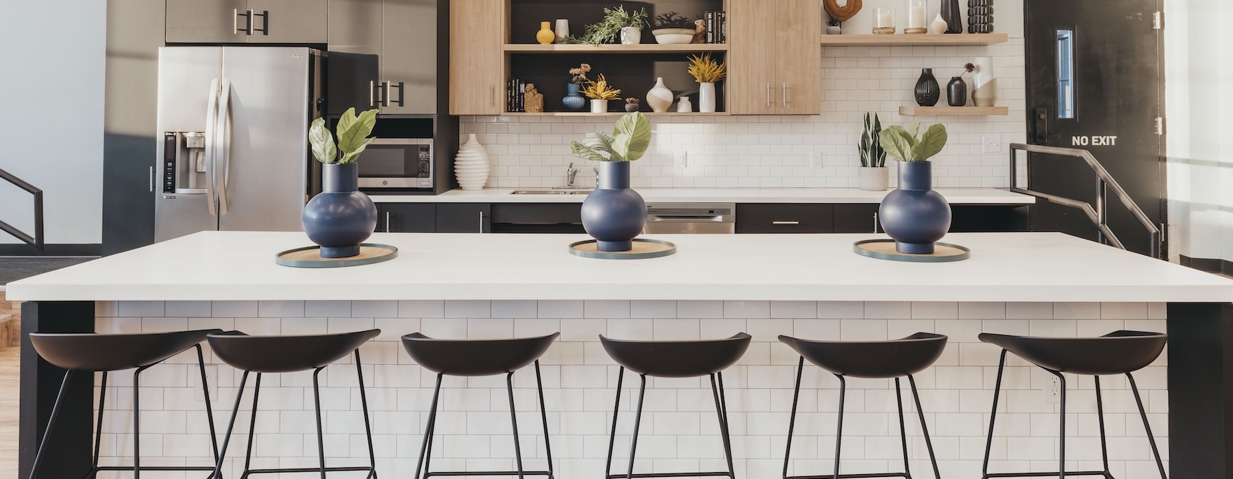 a community kitchen with stools and a table