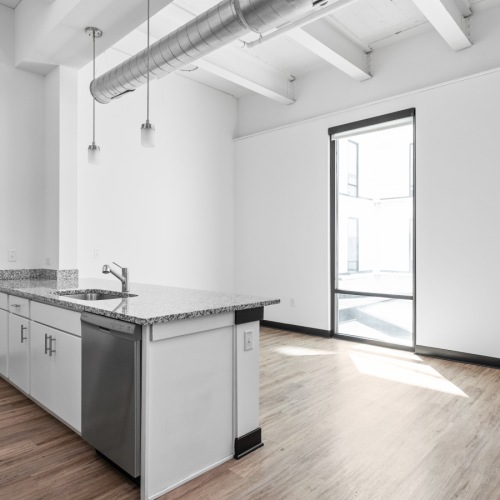 galley kitchen facing large floor to ceiling window