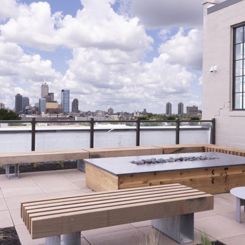 a fire pit with long wooden benches