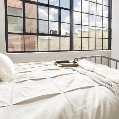 a bed with a white bed spread